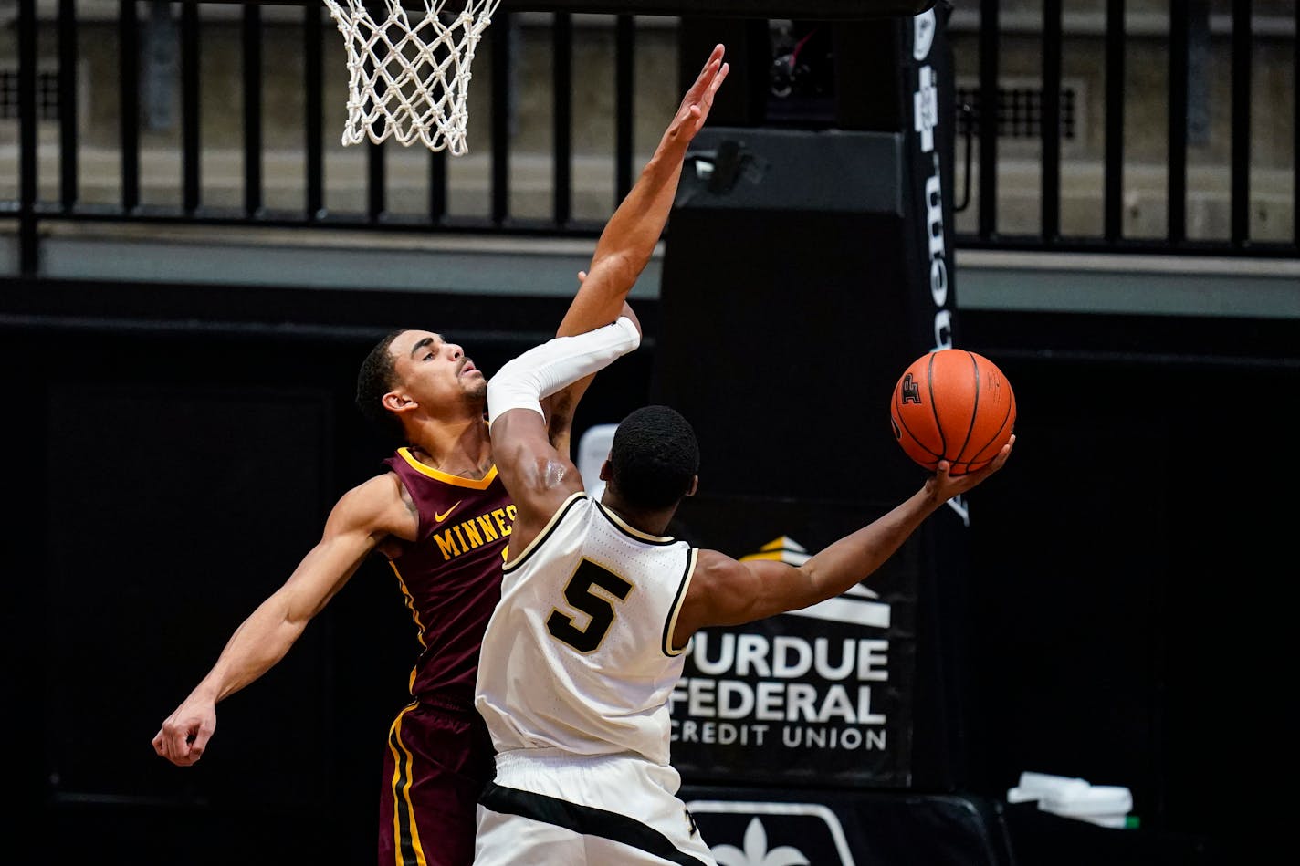 Purdue guard Brandon Newman shoots over Gophers guard Tre' Williams during the first half Saturday.