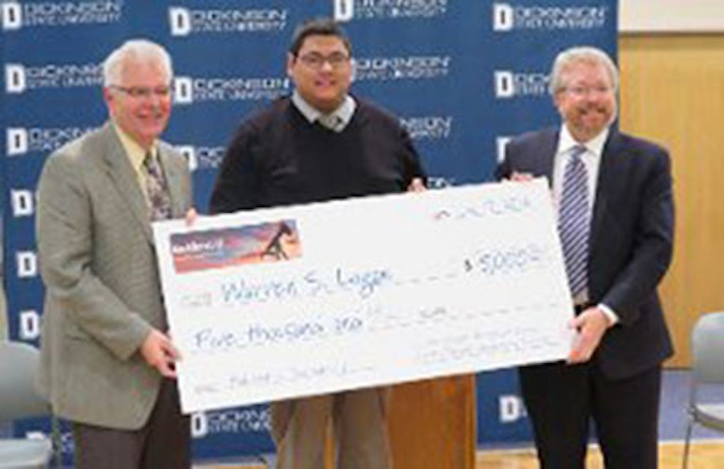 Warren Logan, center, a former oil field worker now enrolled at Dickinson State University, receives the inaugural Bakken U scholarship of $5,000. With him are Bakken U Director Jerry Rostad, left, and Dickinson State University President Thomas Mitzel, right. Logan plans to pursue a degree in business.