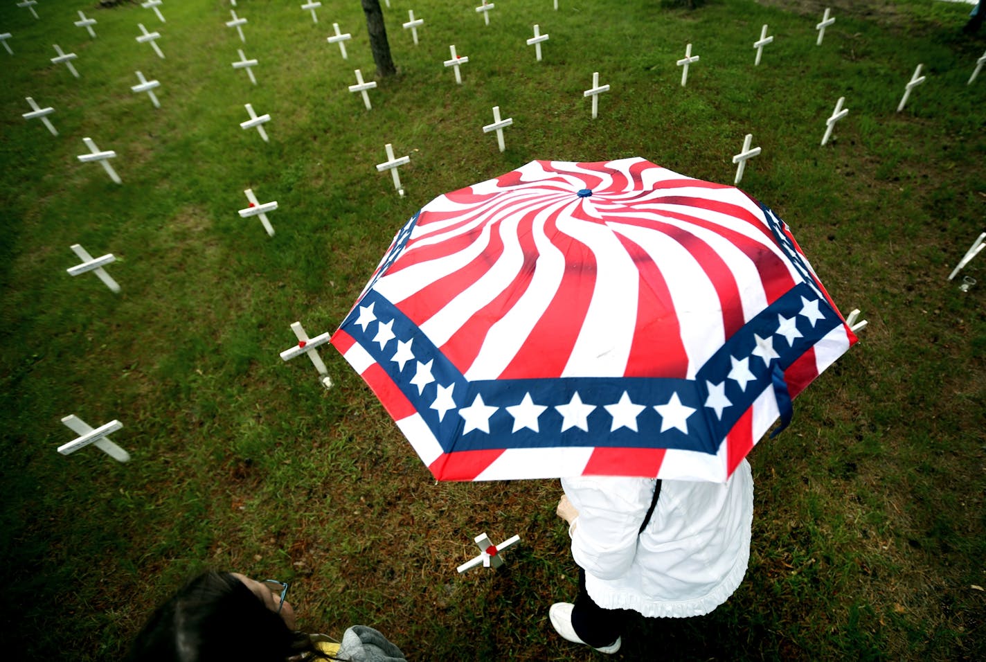 Kathy Henrickson placed a poppy on the cross of Sgt. Nicholas M. Dickhut who was 23 years-old when he was killed in Afghanistan in 2012 during Memorial Day Remembrance at Fort Snelling Veterans Memorial Chapel Sunday May 24, 2015 in Minneapolis, MN.