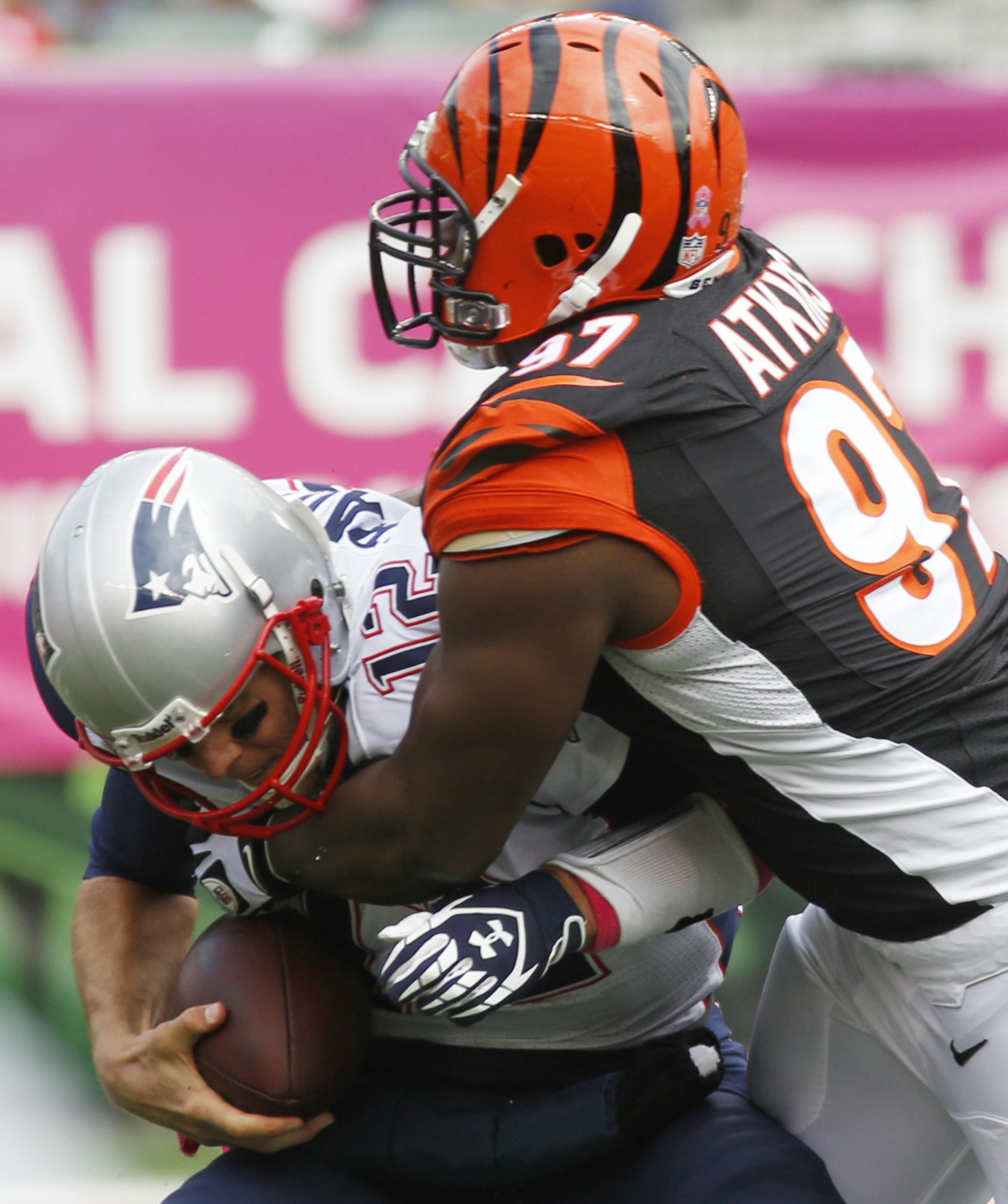 New England Patriots quarterback Tom Brady (12) is sacked by Cincinnati Bengals defensive tackle Geno Atkins (97) in the first half of an NFL football game on Sunday, Oct. 6, 2013, in Cincinnati. (AP Photo/David Kohl)