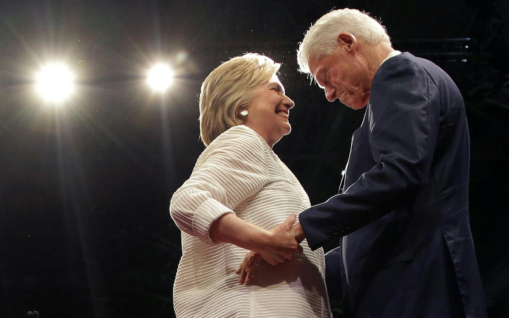 Democratic presidential candidate Hillary Clinton, second from right, greets her husband, former president Bill Clinton during a presidential primary election night rally, Tuesday, June 7, 2016, in New York.