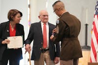Army Sgt. Maj. Jason Rost awards a Purple Heart to Earl Meyer, 96, a retired farmer who was wounded in the Korea War but never received a Purple Heart