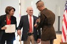 Army Sgt. Maj. Jason Rost awards a Purple Heart to Earl Meyer, 96, a retired farmer who was wounded in the Korea War but never received a Purple Heart