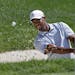 Tiger Woods hits from the sand to the seventh green during the third round of the Bridgestone Invitational golf tournament Saturday, Aug. 3, 2013 at F
