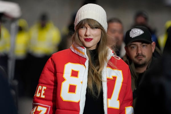FILE - Taylor Swift wears a Kansas City Chiefs tight end Travis Kelce jacket as she arrives before an NFL wild-card playoff football game between the 