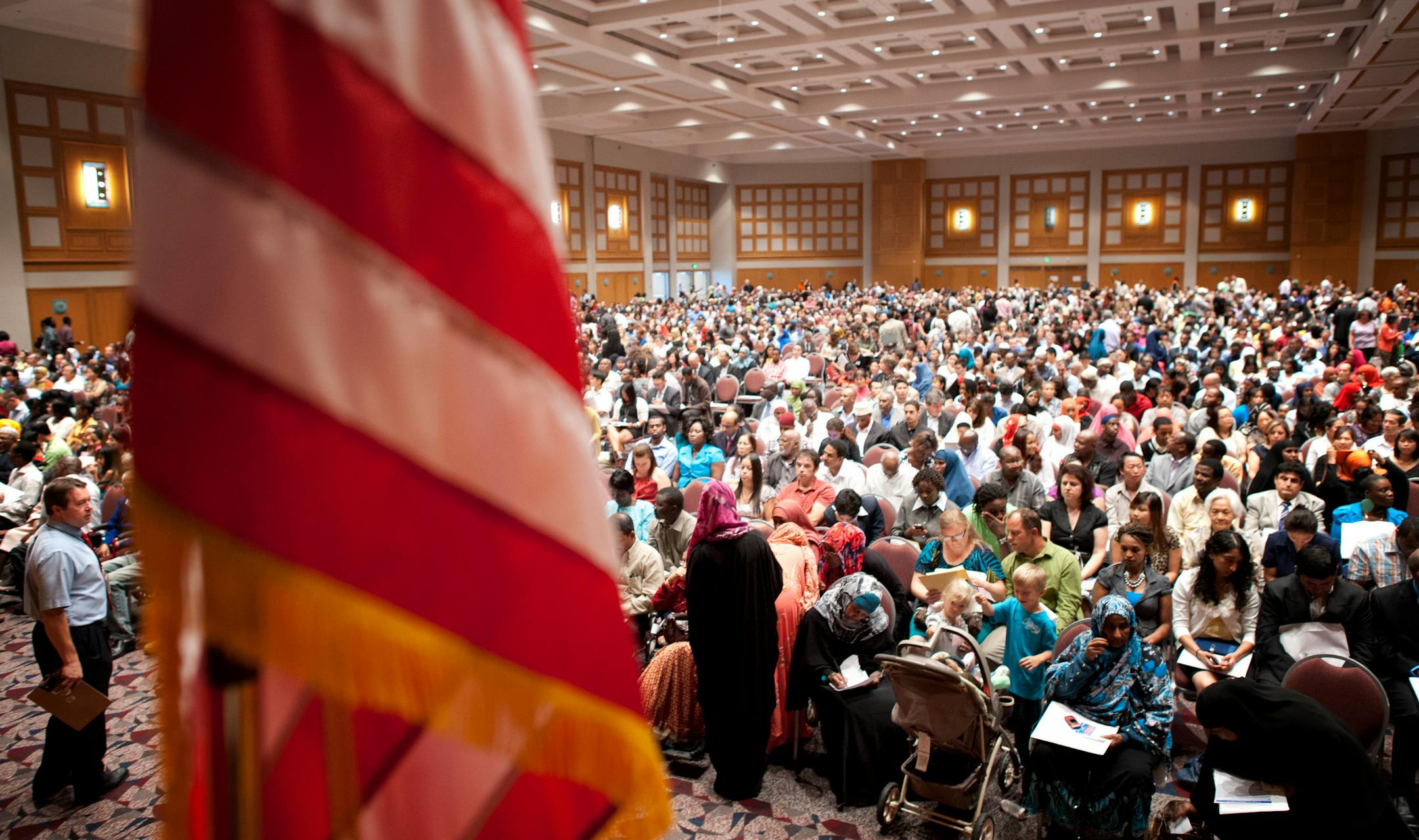 About 1,500 people waited to be sworn in as new U.S. citizens on Thursday at the Minneapolis Convention Center, in what entered the books as the largest naturalization ceremony in Minnesota history. A Sept. 25 ceremony is expected to draw just as many people.