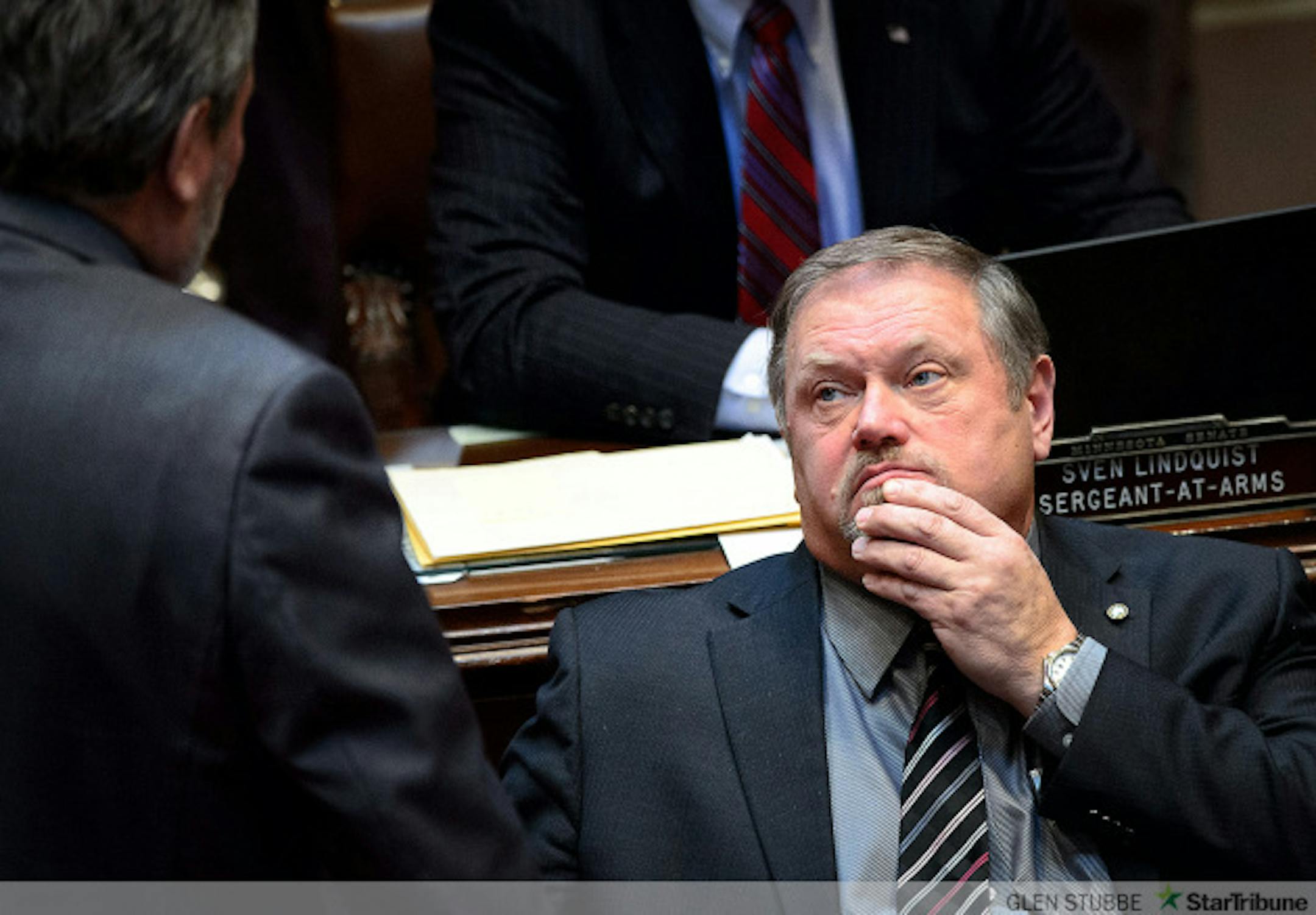 Majority Leader Tom Bakk rubbed his chin as he spoke with Sen Rod Skoe while the Senate debated the bill with Bakk's amendment that would delay raises for Governor Dayton's commissioners.    ] GLEN STUBBE * gstubbe@startribune.com Thursday, February 12, 2015