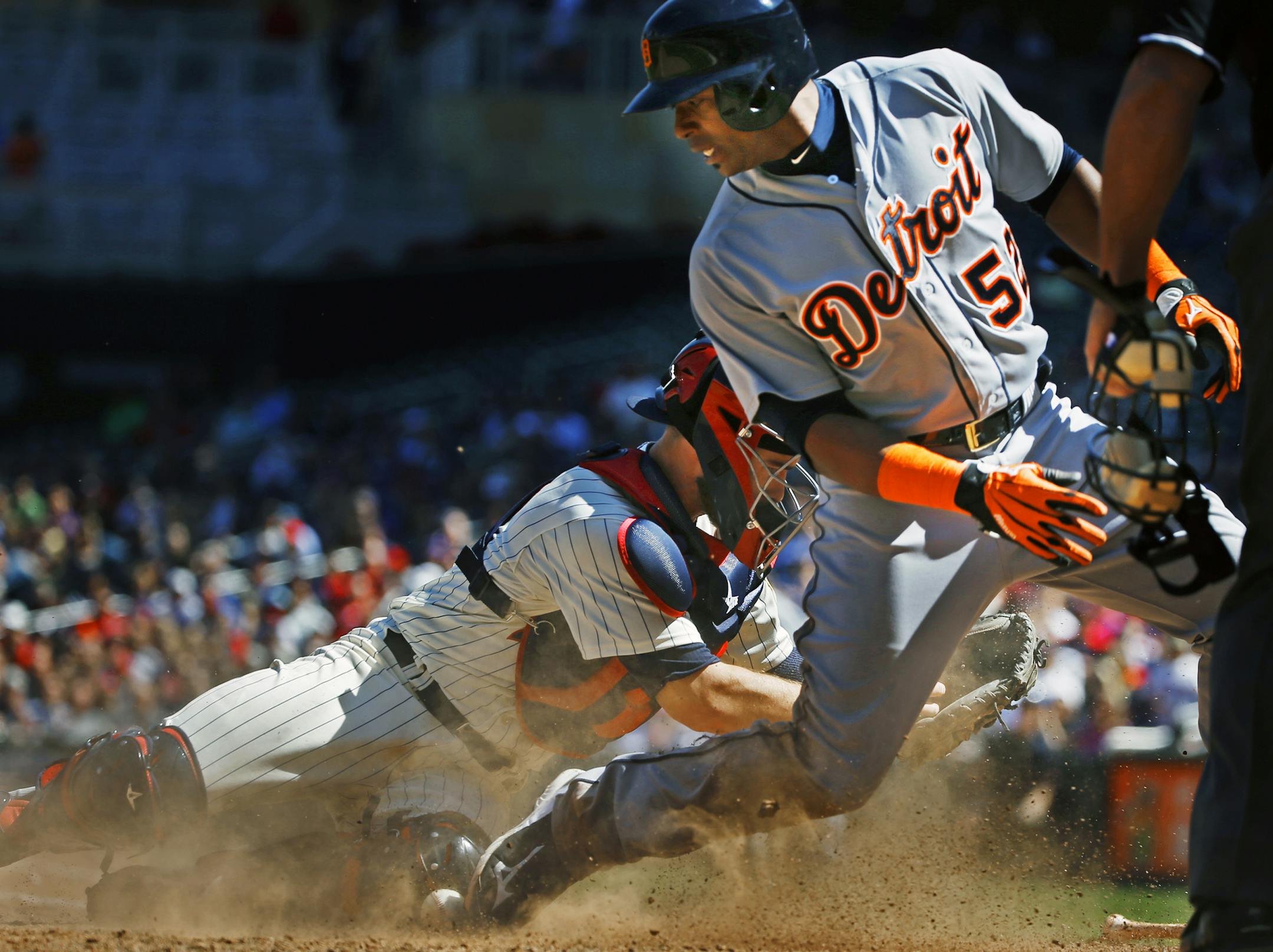 At Target Field in a game between the Twins and the Tigers, catcher Chris Hermann(12) drops the ball as Yoenis Cespedes(52) scores at home in the 8th inning.] Richard Tsong-Taatarii/rtsong-taatarii@startribune.com