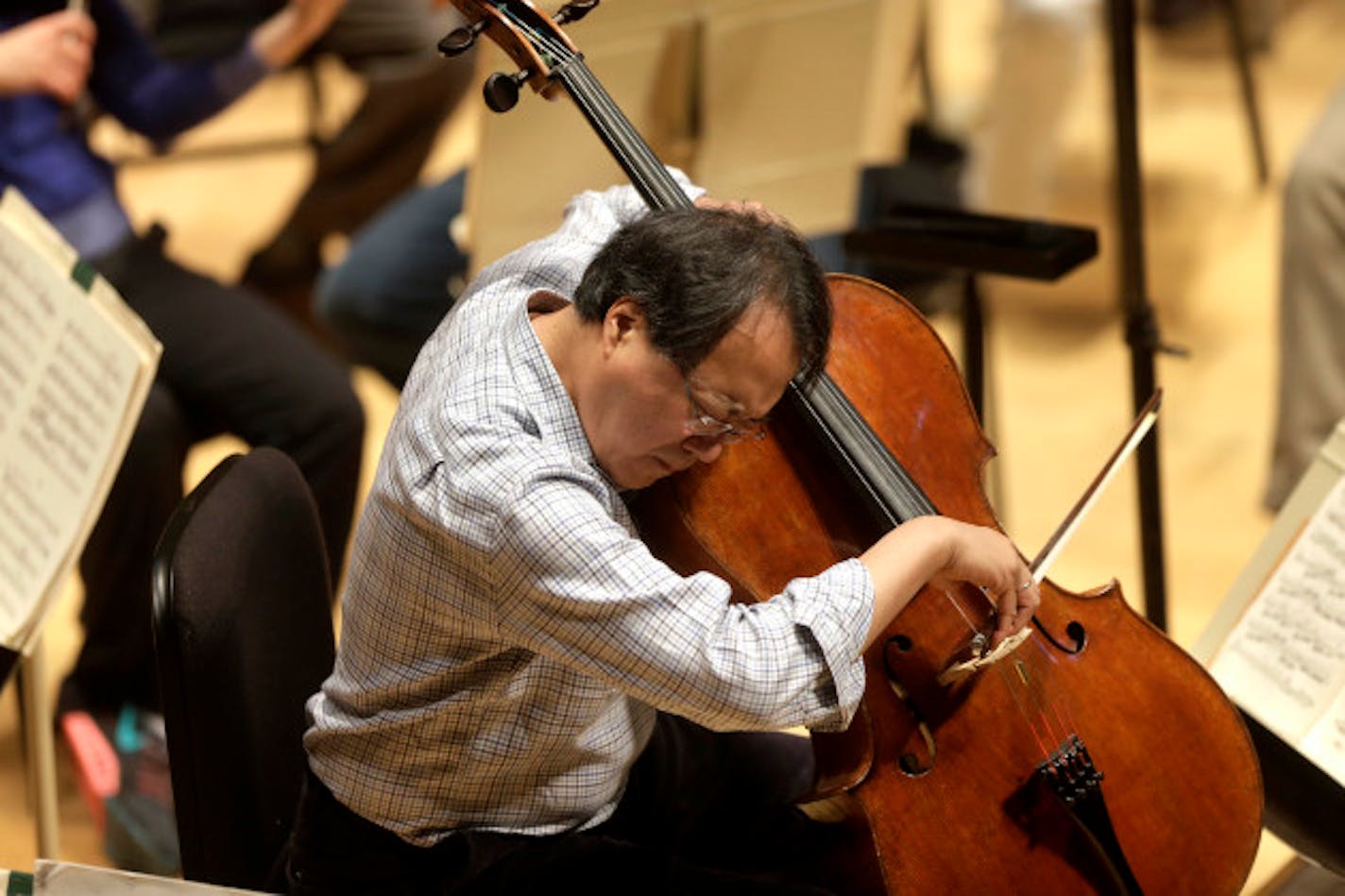 Cellist Yo-Yo Ma rehearses Prokofiev's Symphony Concerto for cello and orchestra at Symphony Hall, Thursday, Nov. 20, 2014, in Boston. Ma is to perform the piece with the BSO in a Thursday, Nov. 20 evening performance to be conducted by Boston Symphony Orchestra Music Director Andris Nelsons. (AP Photo/Steven Senne)