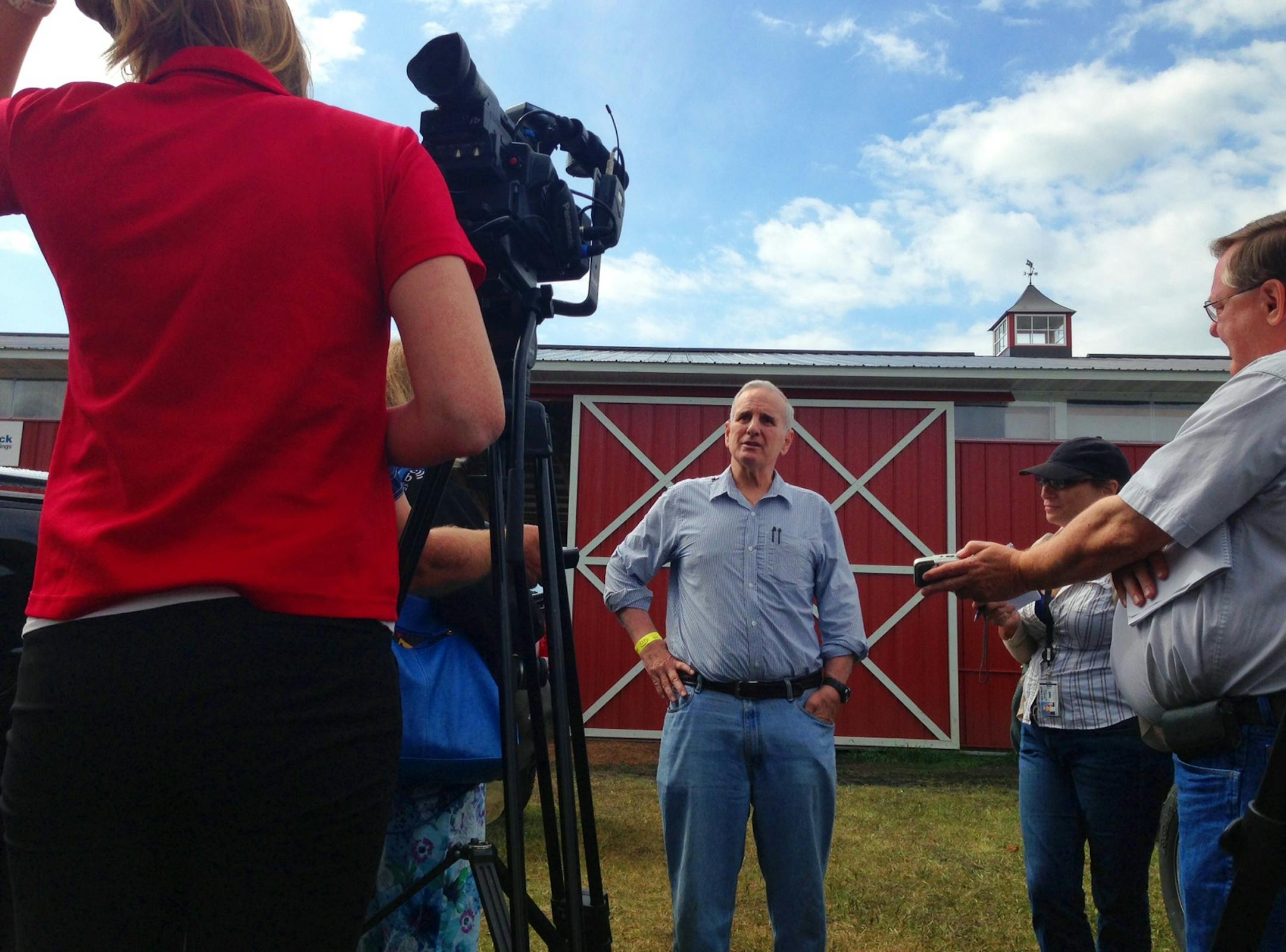 Gov. Mark Daytom takes questions at Farmfest near Redwood Falls, Minn., Thursday.
