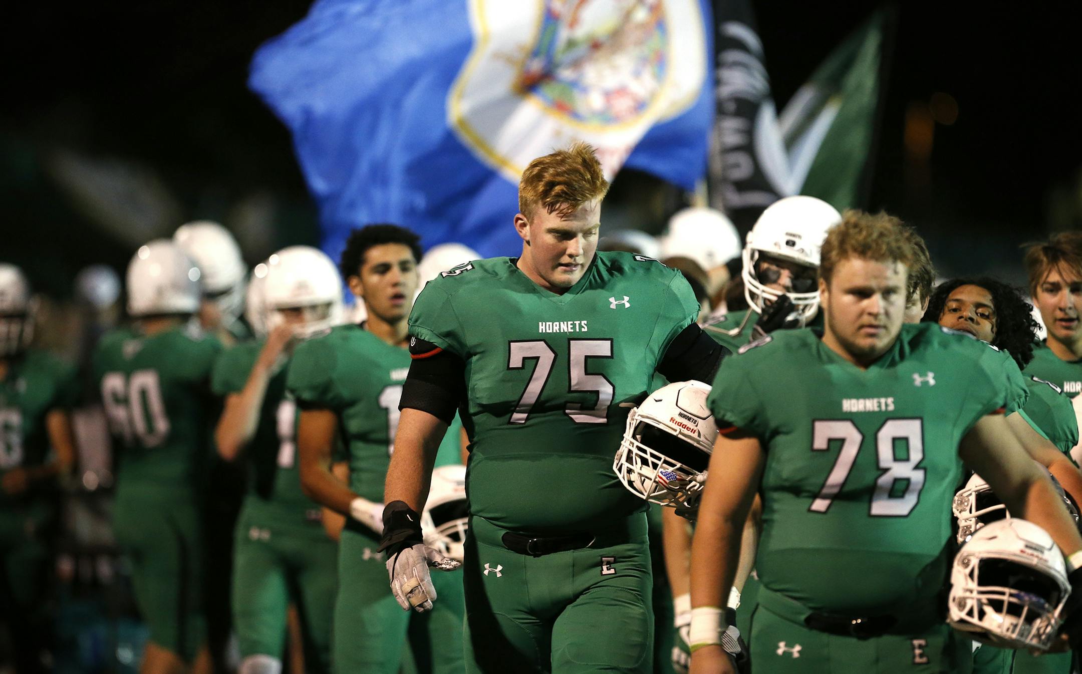 Edina High School offensive lineman Quinn Carroll (75) walks out with his teammates before the start of the game. ] LEILA NAVIDI ï leila.navidi@startribune.com BACKGROUND INFORMATION: Eden Prairie High School football at Edina High School on Wednesday, October 18, 2017.