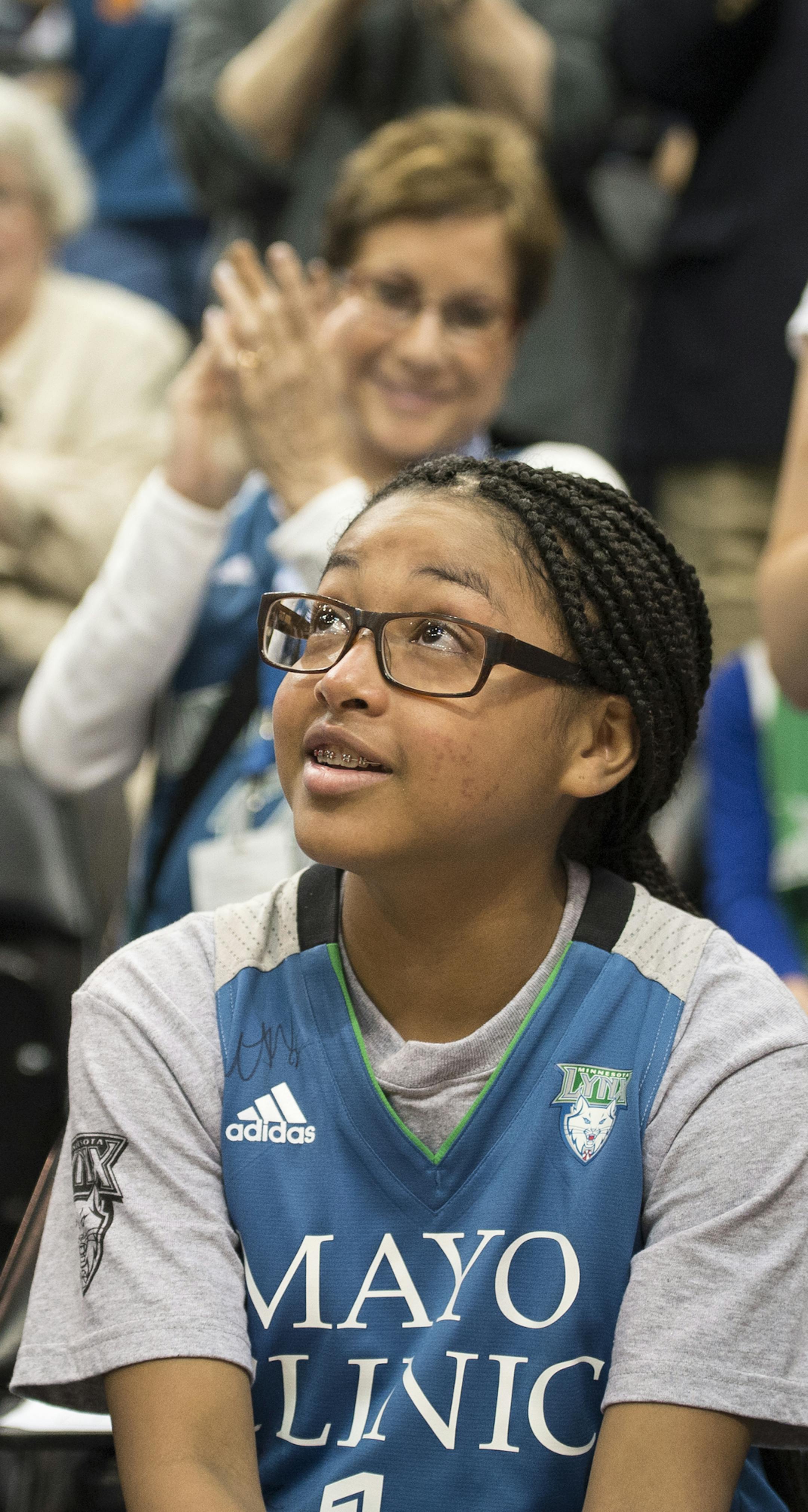 Ariya Smith, a 14-year-old from Colorado suffering from systemic lupus, looked on as the crowd cheered for her during her introduction as part of the Lynx Thursday. ] Aaron Lavinsky • aaron.lavinsky@startribune.com The Minnesota Lynx play the Seattle Storm on Thursday, June 11, 2015 at Target Center in Minneapolis, Minn. ORG XMIT: MIN1506112000320766