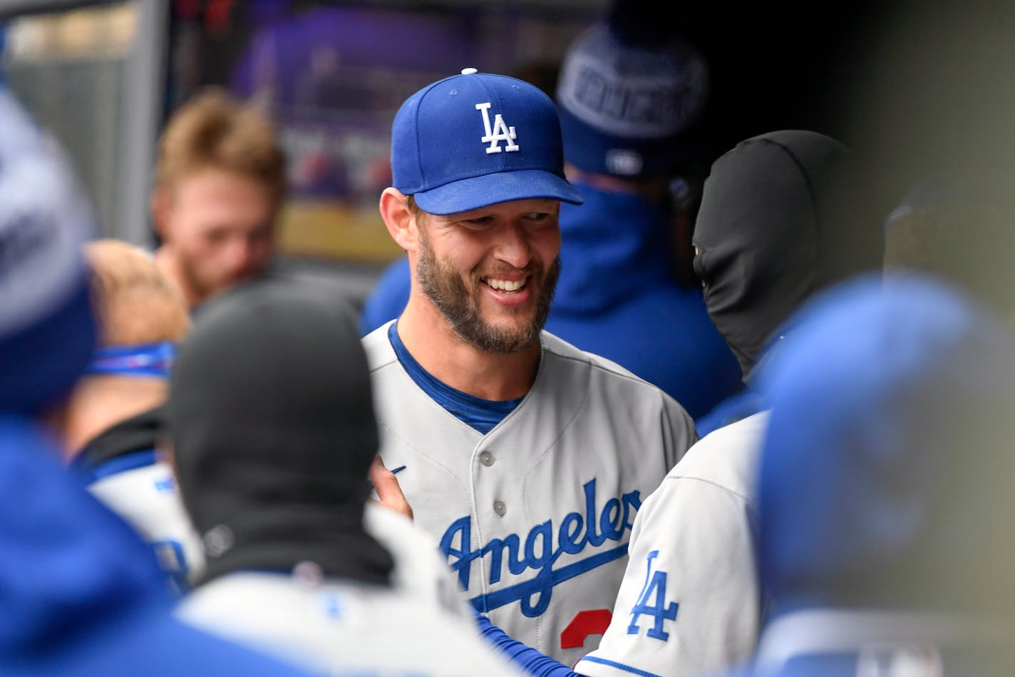 Los Angeles Dodgers pitcher Clayton Kershaw celebrates with teammates after a perfect game through seven innings in his season debut, dominating the Minnesota Twins with 13 strikeouts in 21 batters on Wednesday, April 13, 2022, in Minneapolis. (AP Photo/Craig Lassig)