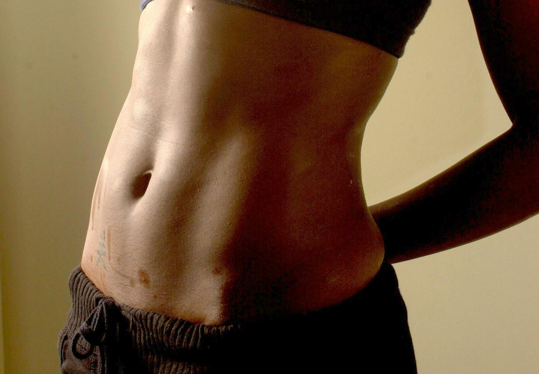 Candy Taylor, assistant manager, of Ladies Choice Fitness Center in Columbia, South Carolina, shows off her abdominal muscles.