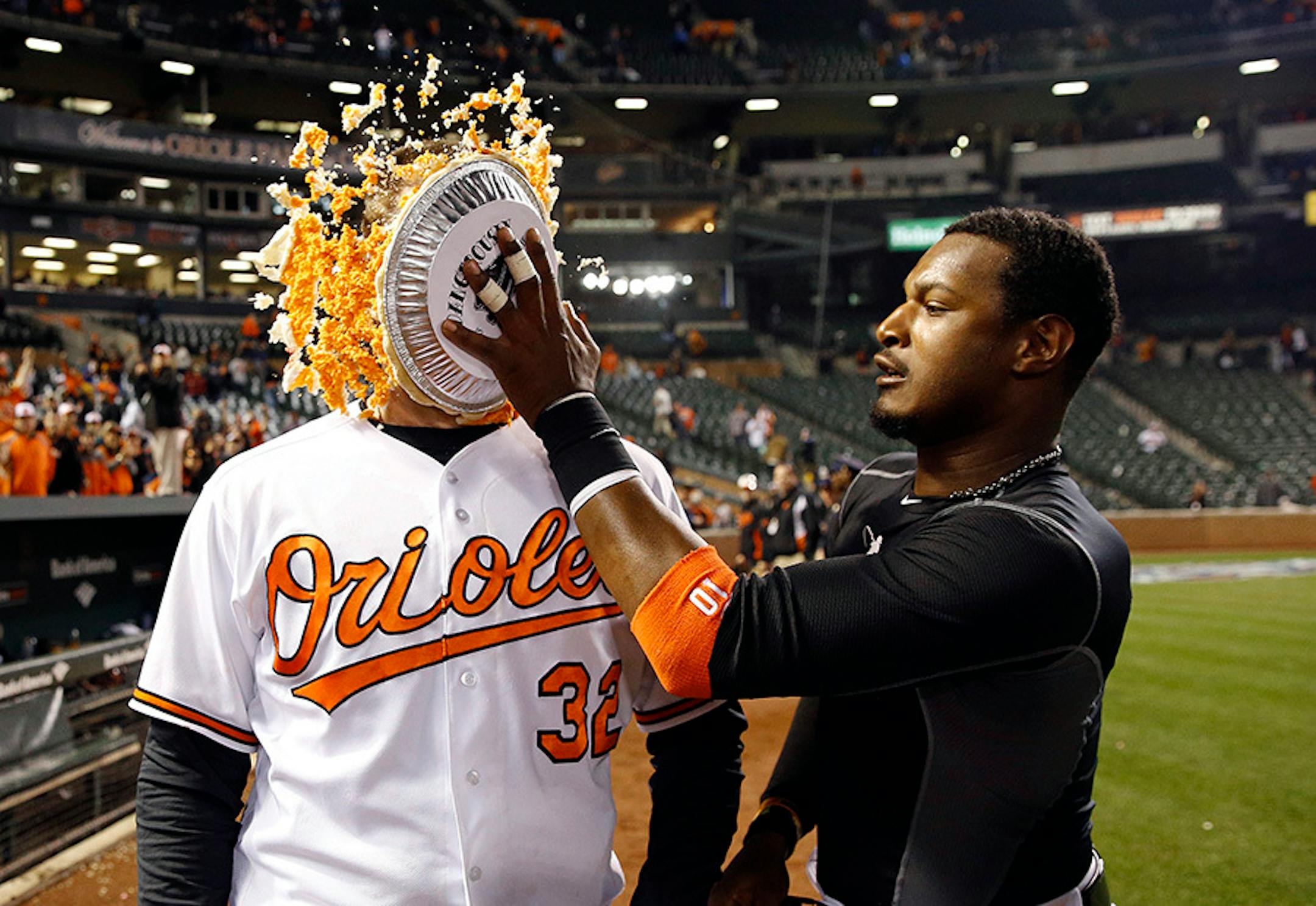Baltimore Orioles' Adam Jones, right, hits teammate Matt Wieters in the face with a pie after an opening day baseball game against the Minnesota Twins in Baltimore, Monday, April 4, 2016. Wieters drove in the winning run on a single and Baltimore won 3-2.