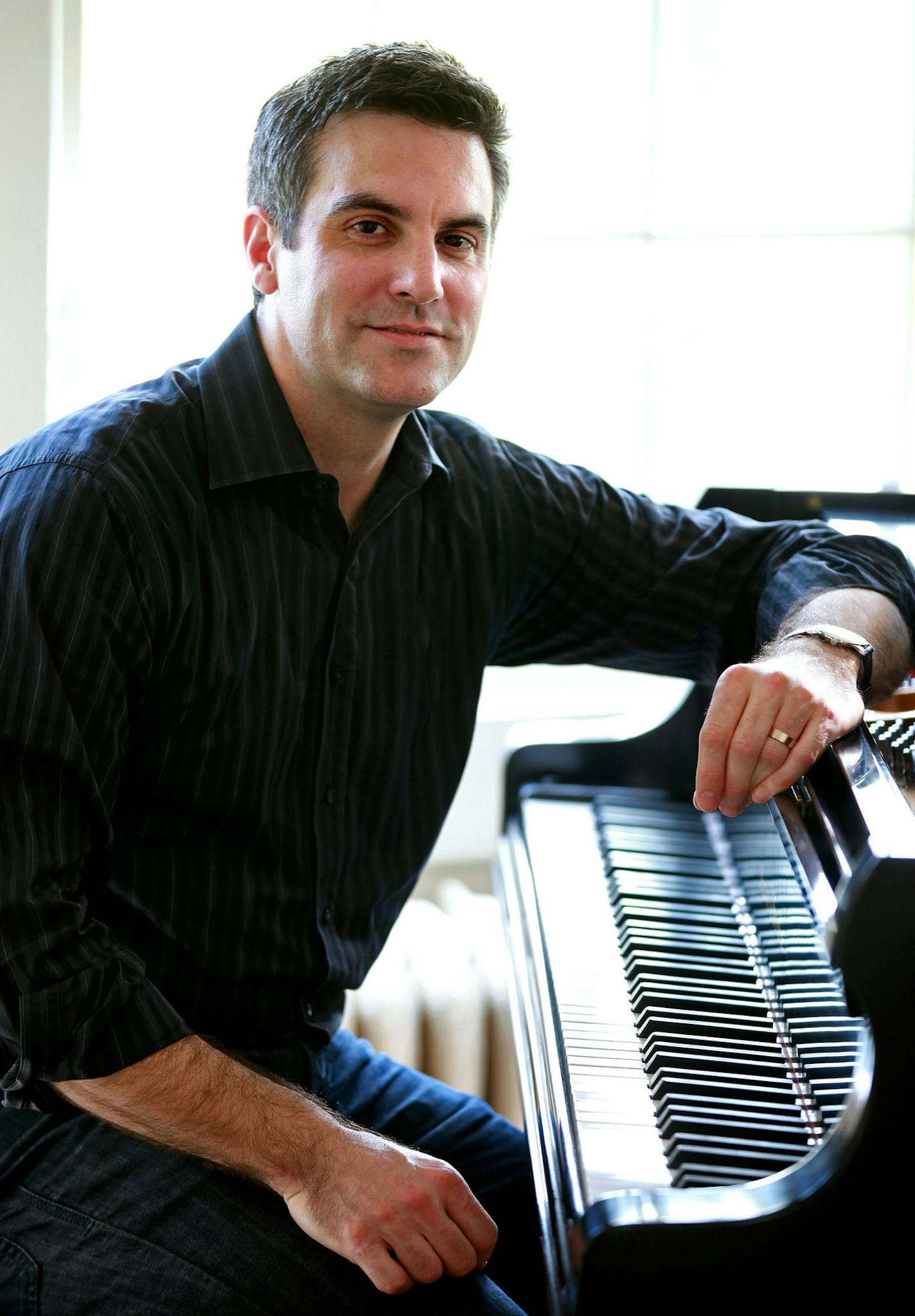 Composer Kevin Puts sits by his piano at his home in Yonkers, N.Y. on Monday, April 16, 2012. Puts received the 2012 Pulitzer Prize in Music for his opera "Silent Night: Opera in Two Acts." (AP Photo/Craig Ruttle) ORG XMIT: NYCR105