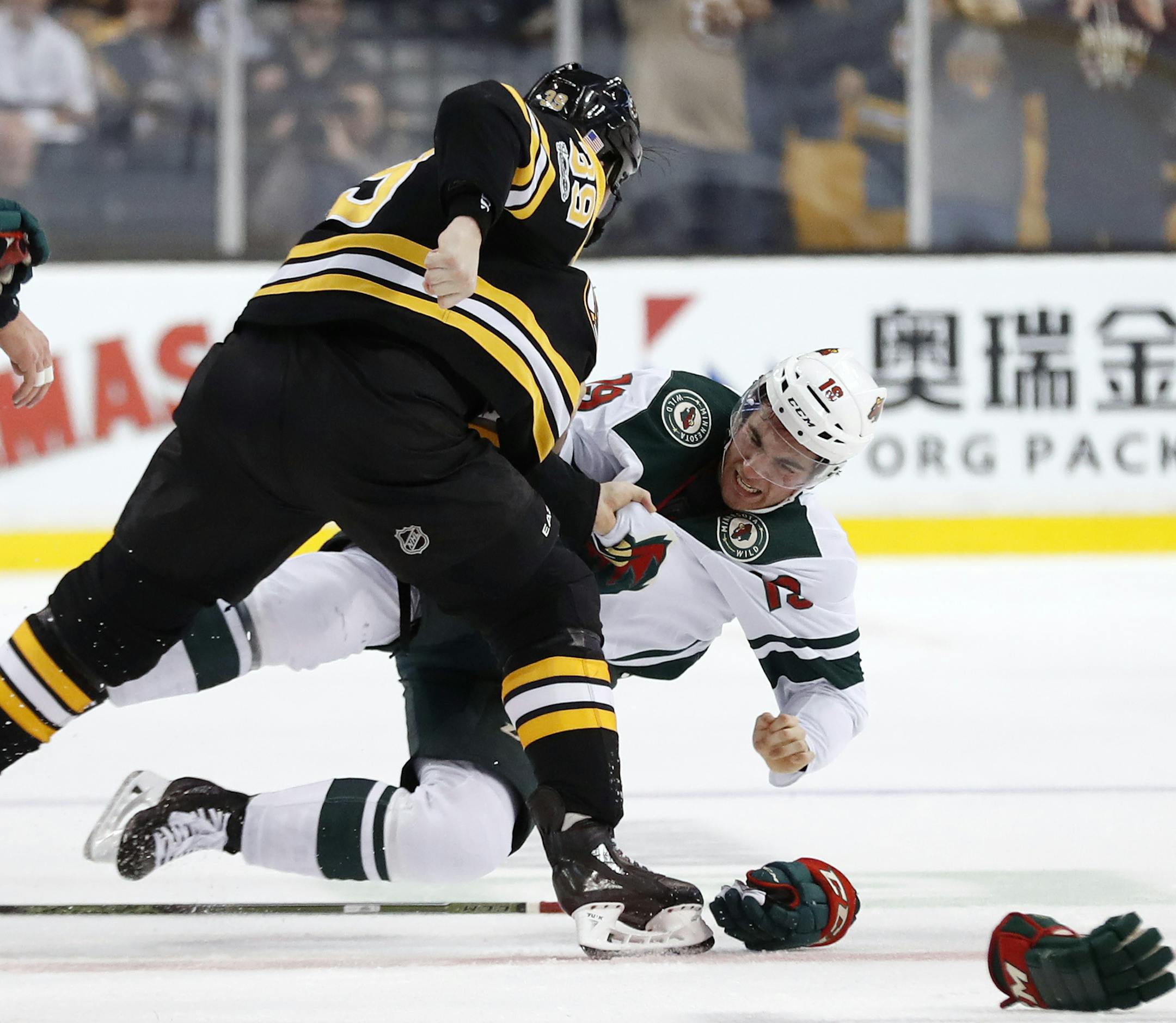 Boston Bruins' Matt Beleskey knocks Minnesota Wild's Luke Kunin to the ice during a fight in the first period of an NHL hockey game in Boston Monday, Nov. 6, 2017. (AP Photo/Winslow Townson)