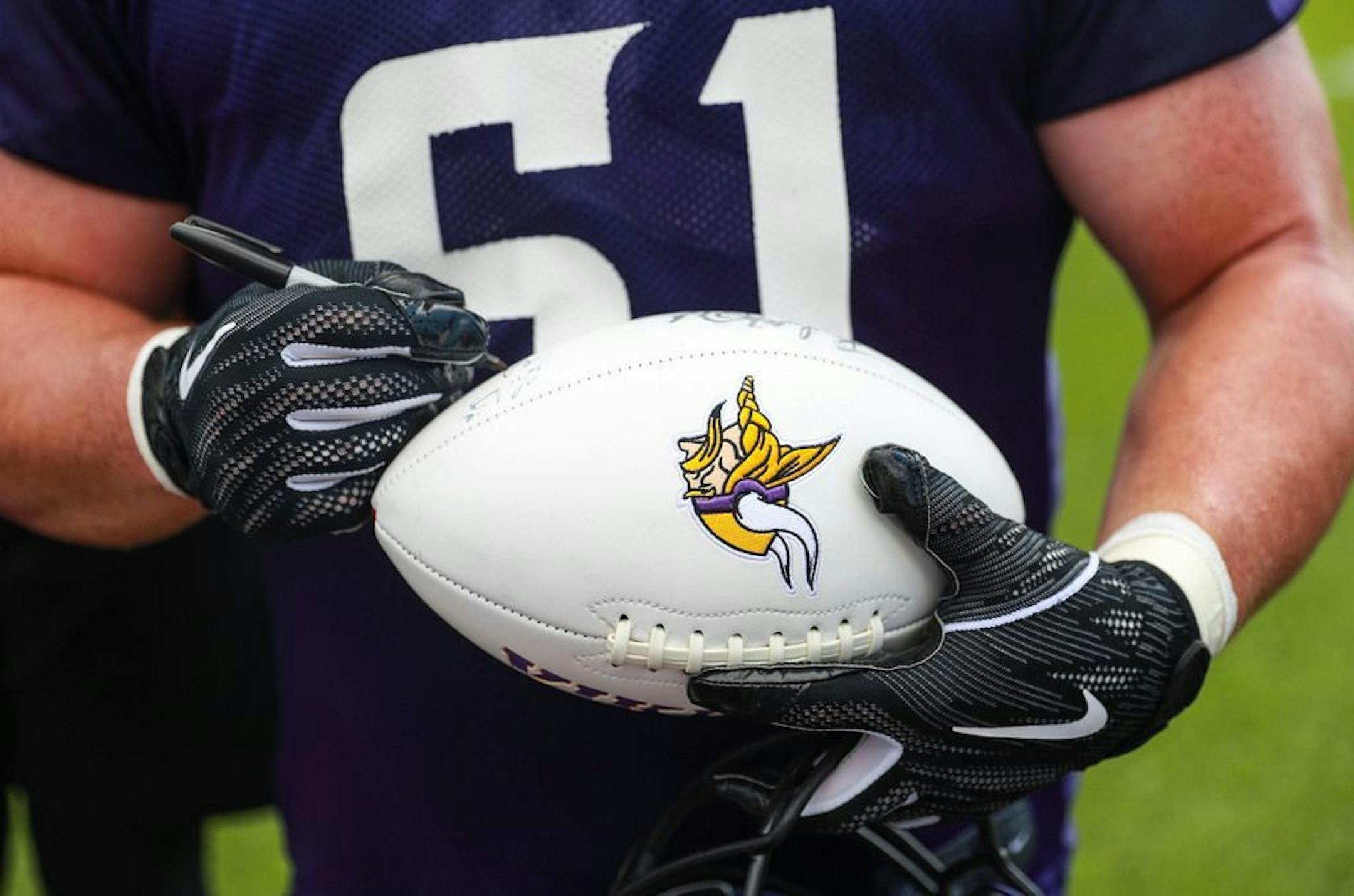 Minnesota Vikings center Brett Jones (61) signed autographs for kids on the sidelines after practice on Friday. ALEX KORMANN • alex.kormann@startribune.com The Minnesota Vikings opened up their first full day of training camp on Friday July 26, 2019 at TCO Performance Center in Eagan, MN. Doors opened to fans at 11AM to watch their favorite players practice and get excited for the 2019 NFL season.