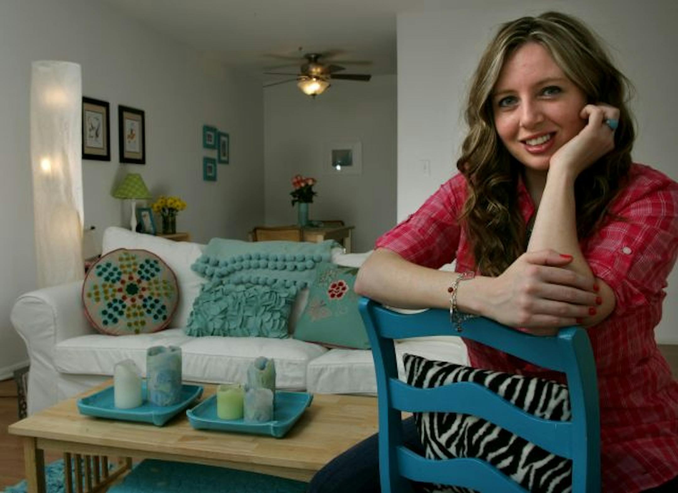 Erin Olson loves her white couch that shows off her continually changing accessories. Her favorite piece is the blue desk chair with zebra-print seat she re-did herself.