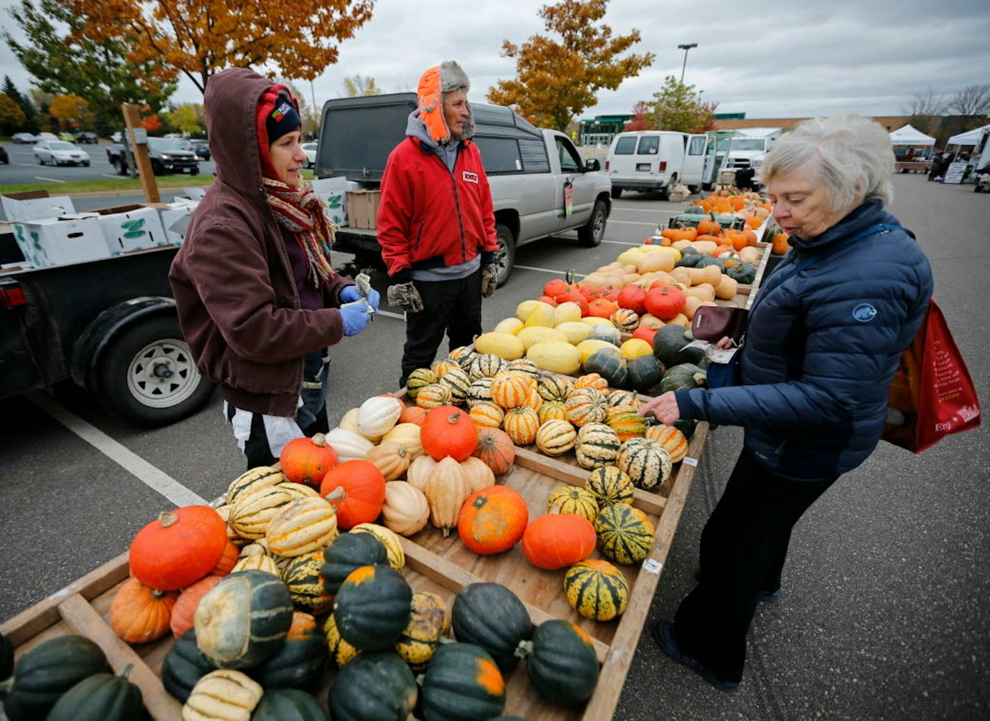 Anna and John Mau with Mau Family Produce brought gourds and pumpkins to the Maple Grove Farmers Market on Thursday, catching the eye of Yvonne Palka of Maple Grove.