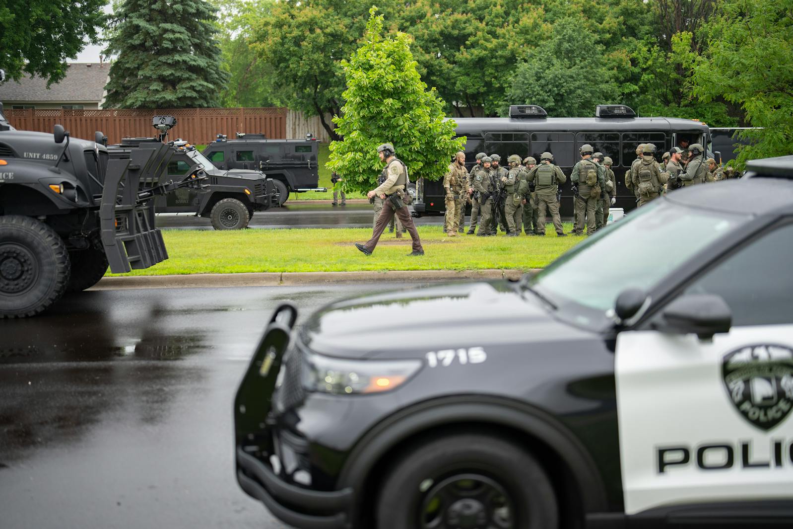At least 100 law enforcement officers including local police, sheriffs and the FBI, stage less than a mile from the home of state Rep. Melissa Hortman in Brooklyn Park on Saturday.