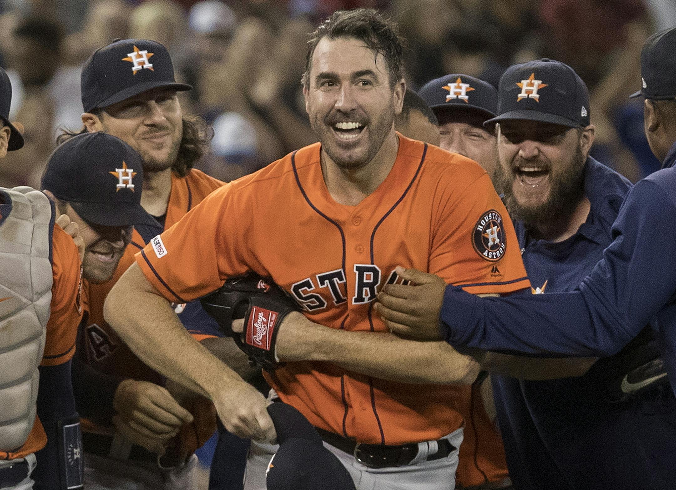 Houston Astros starter Justin Verlander is mobbed by teammates after pitching a no-hitter against the Toronto Blue Jays in a baseball game in Toronto, Sunday, Sept. 1, 2019. (Fred Thornhill/The Canadian Press via AP)