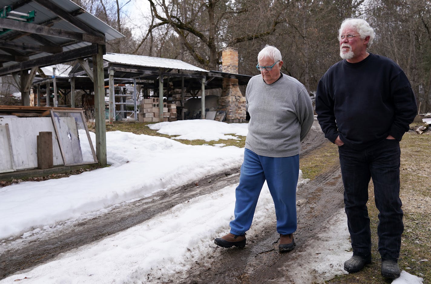 Mel Jacobson, left, an 85-year-old from Minnetonka who retreated to his remote cabin across the St. Croix River to wait out the Coronavirus pandemic, took a walk around his property with is neighbor Rod Hyde. ] ANTHONY SOUFFLE &#x2022; anthony.souffle@startribune.com Mel Jacobson, an 85-year-old from Minnetonka who retreated to his remote cabin across the St. Croix River to wait out the Coronavirus pandemic, took a walk around his property with neighbors Tuesday, March 24, 2020 in Clear Lake, Wi