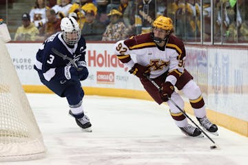 Gophers hockey forward Logan Cooley stickhandled behind the net Thursday against Penn State in the opener of a Big Ten series at 3M Arena at Mariucci.