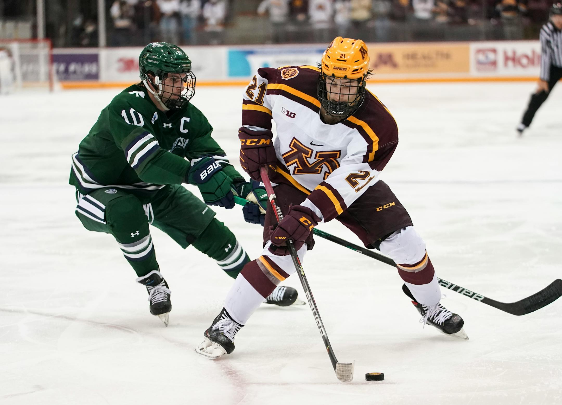 Minnesota forward Grant Cruikshank (21) skated around Mercyhurst forward Geoff Kitt (10) in the second period.