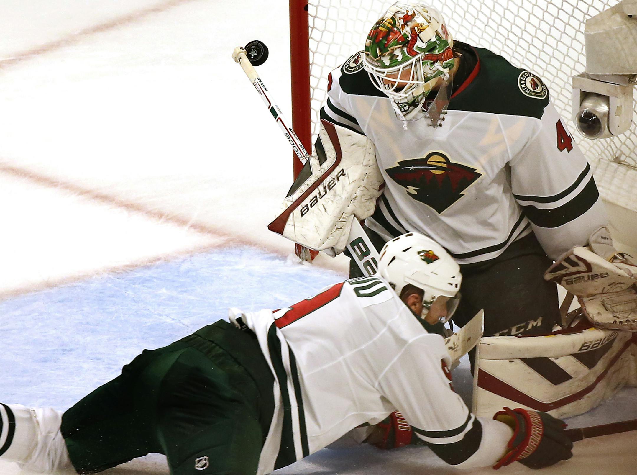The puck shot by Jonathan Toews (19) got past Wild goalie Devan Dubnyk (40) for a goal in the second period.