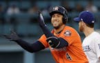 Houston Astros' George Springer reacts after hitting a double during the first inning of Game 7 of baseball's World Series against the Los Angeles Dod