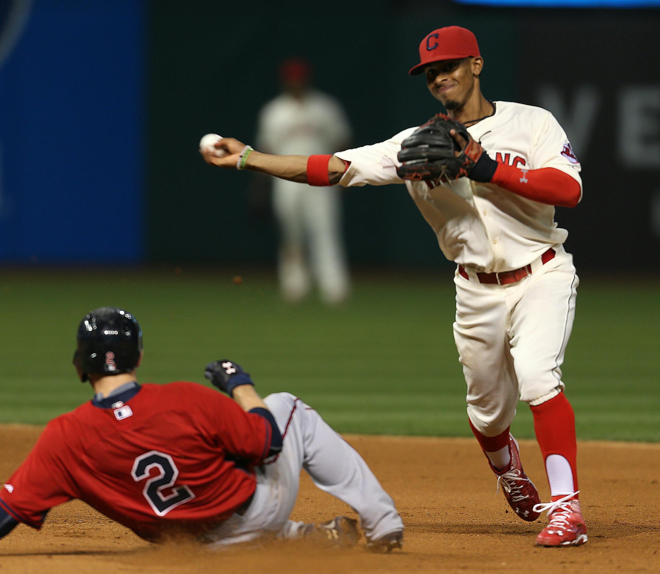 Cleveland Indians shortstop Francisco Lindor turns a double play over Minnesota Twins' Brian Dozier during the fifth inning of a baseball game, Saturday, Aug. 8, 2015, in Cleveland. (AP Photo/Ron Schwane)