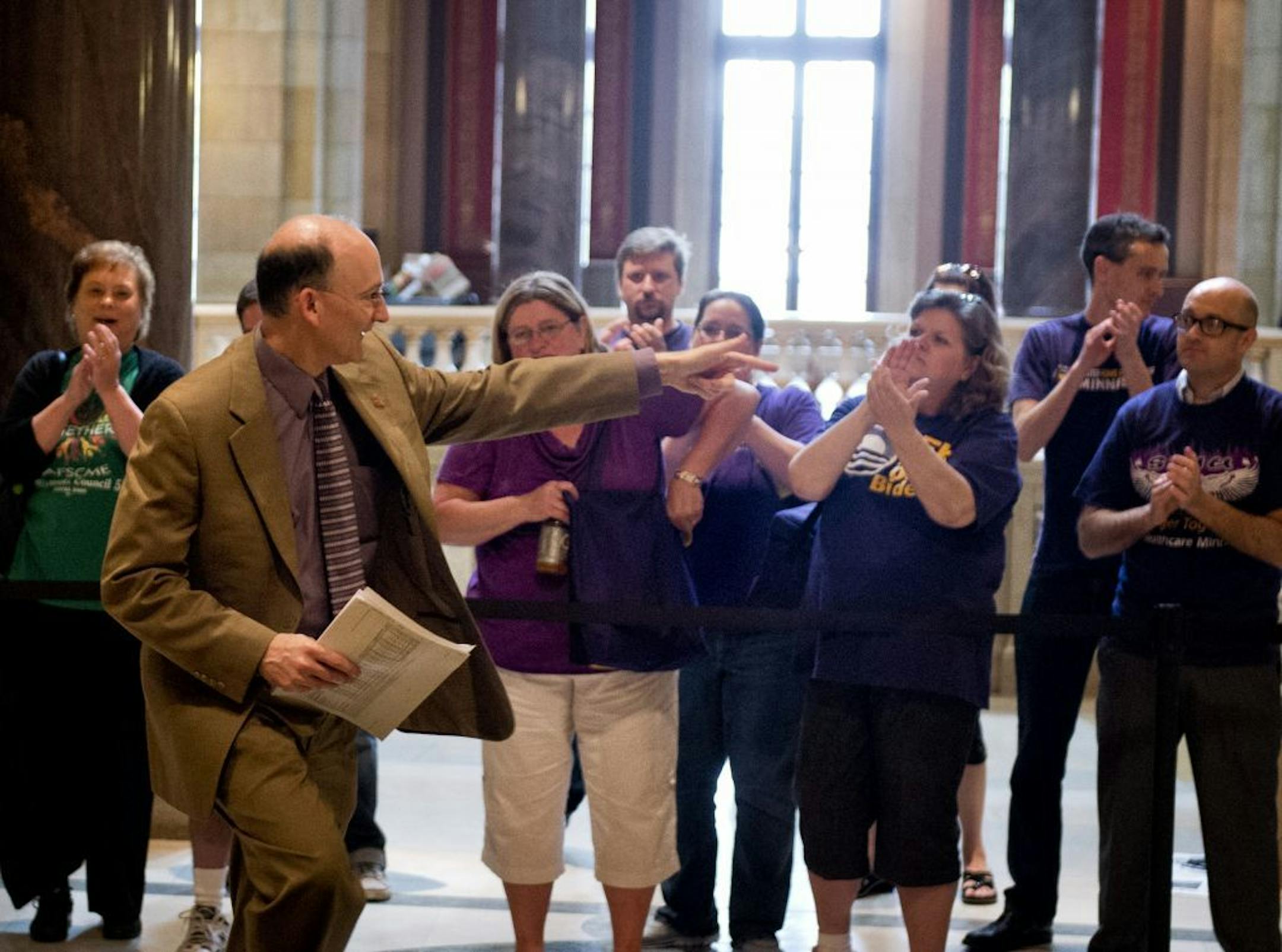Rep. Peter Fisher greeted advocates on both sides of the daycare unionization bill as he entered the House Chamber. After adjourning at 7:00 a.m., legislators were back at work 5 hours later at noon and were greeted by around a dozen advocates from both sides of the daycare unionization issue. Sunday, May 19, 2013