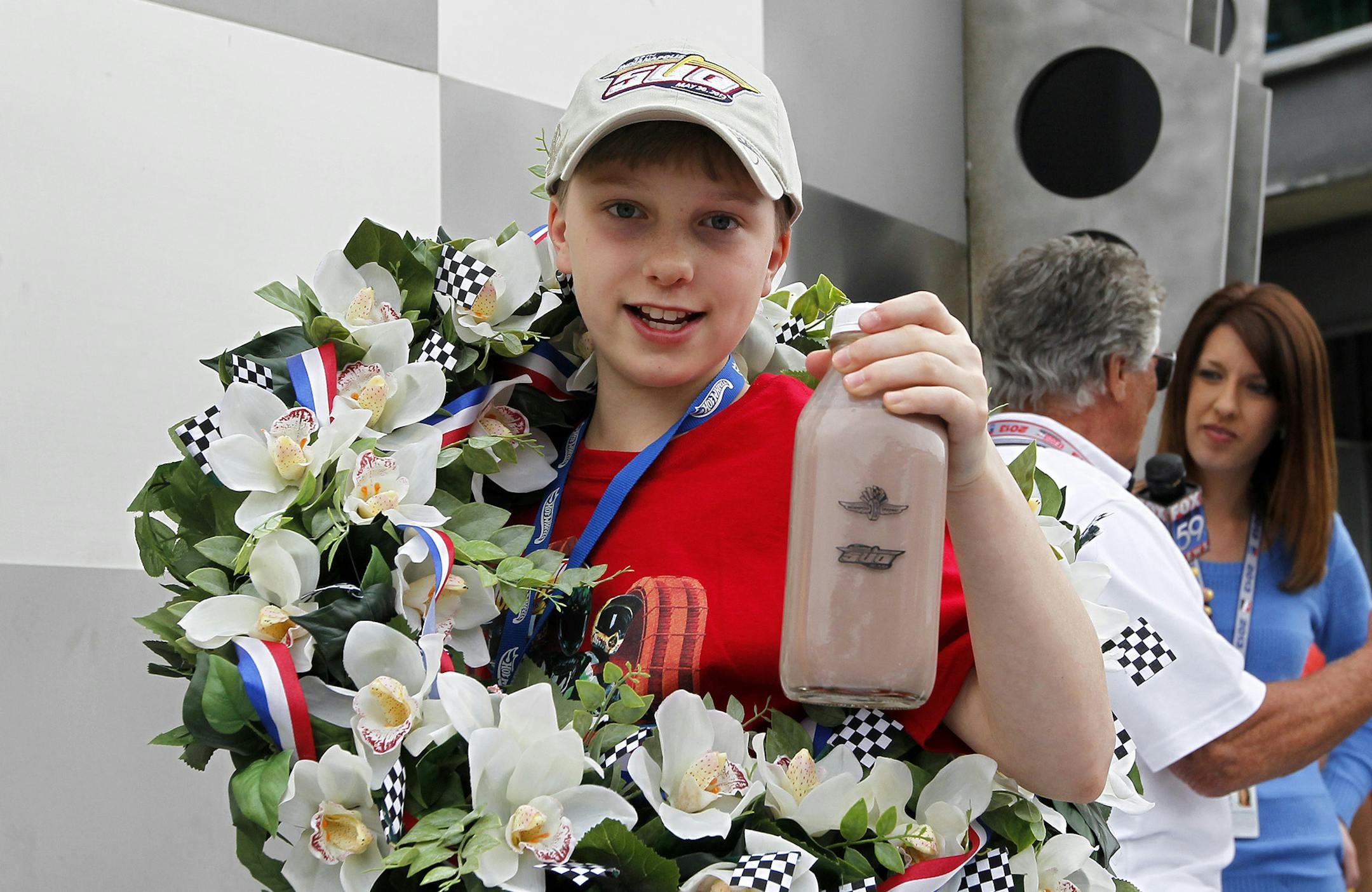 Christopher Bienusa, a 12-year-old from Alexandria, Minn., celebrates winning the Hot Wheels "World's Best Driver Championship" in traditional Indy 500 fashion on Saturday, May 25 at the Indianapolis Motor Speedway. Coached by racing legends Mario and John Andretti, Bienusa's toy-sized car finished first on the world record-setting one mile-long iconic Hot Wheels orange toy track.(Photo by Phil Abbott/Invision for Hot Wheels/AP Images)