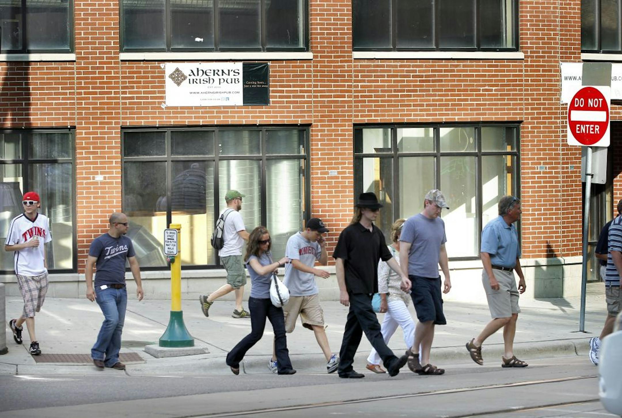Twins fans walk past one of the biggest mysteries in downtown Minneapolis is Ahern's Irish Pub. The massive bar has gone unfinished for two years, located on prime real estate one block from Target Field, 126 Fifth Street North.