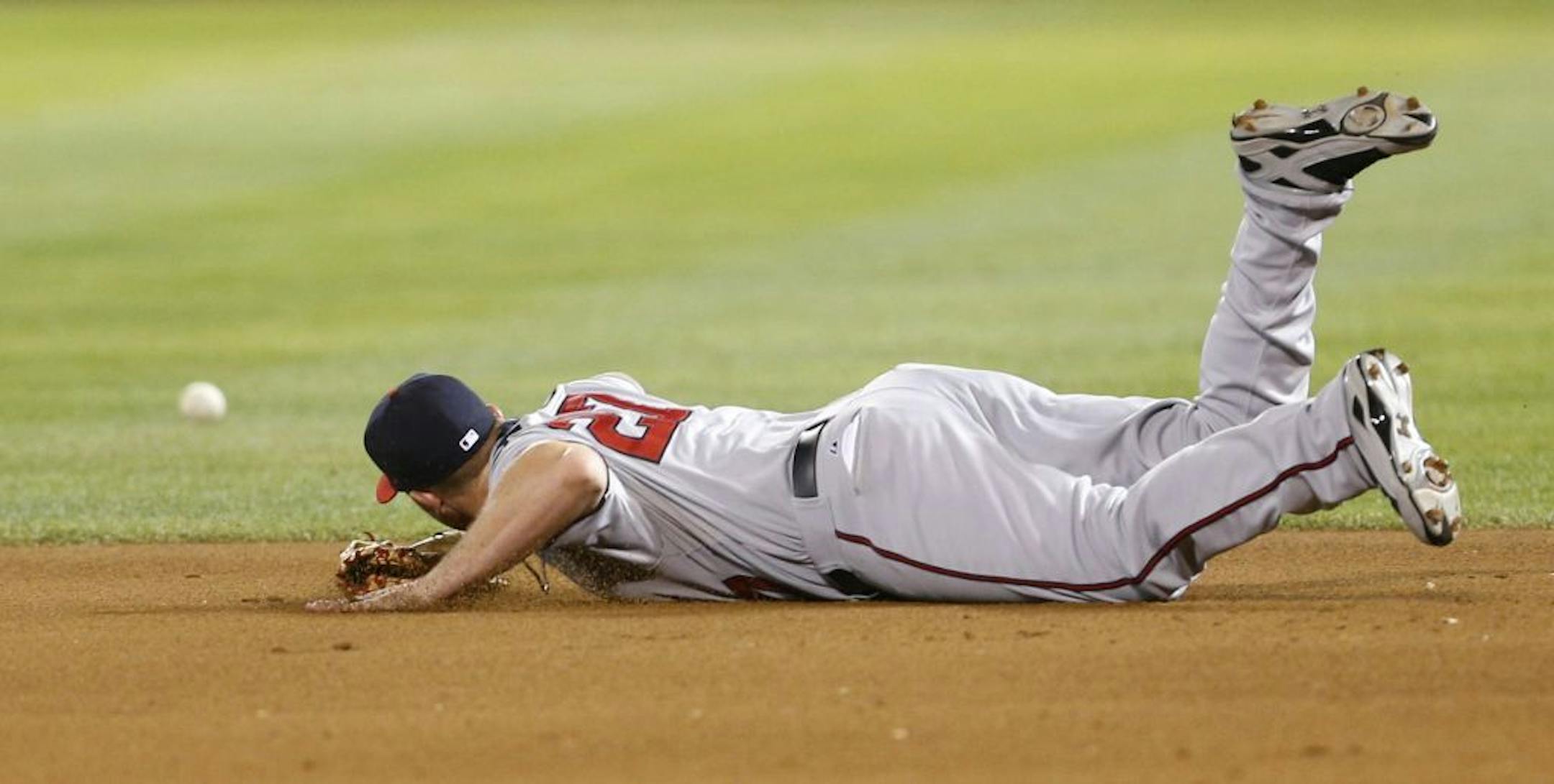 Minnesota Twins' Chris Parmelee (27) is unable to stop a ground ball by Oakland Athletics' Alberto Callaspo during the fifth inning of a baseball game, Friday, Sept. 20, 2013, in Oakland, Calif.