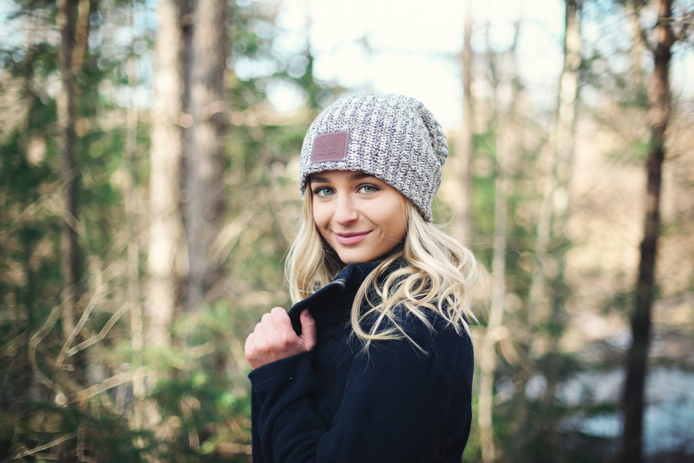 A model wears a Love Your Melon beanie.