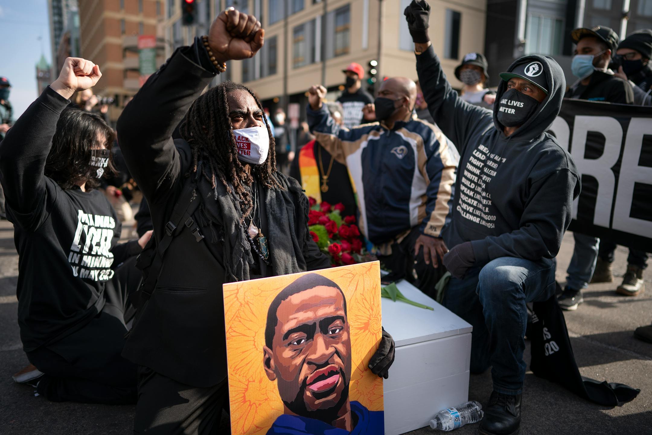 Cortez Rice left, of Minneapolis, sat in the middle of Hennepin Avenue to mourn the death of George Floyd.