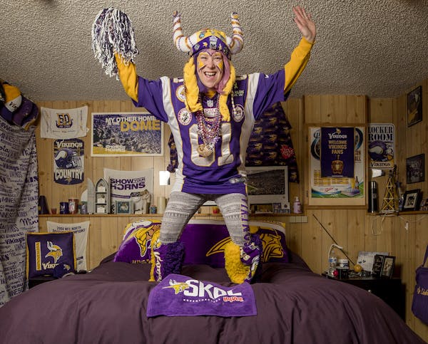 Vikings superfan Lindsey "Purplelicious" Lorentson at home with some of her memorabilia. "I'm not afraid. ... This year feels different," she said.