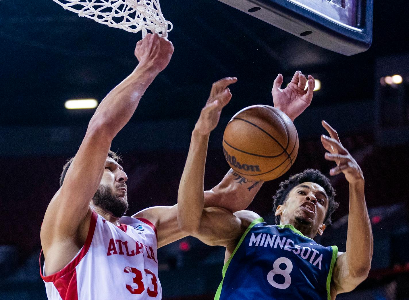 Atlanta Hawks forward Uros Plavsic (33) and Minnesota Timberwolves forward Josh Minott (8) vie for the ball during the first half of an NBA summer league basketball game Wednesday, July 12, 2023, in Las Vegas. (L.E. Baskow/Las Vegas Review-Journal via AP)