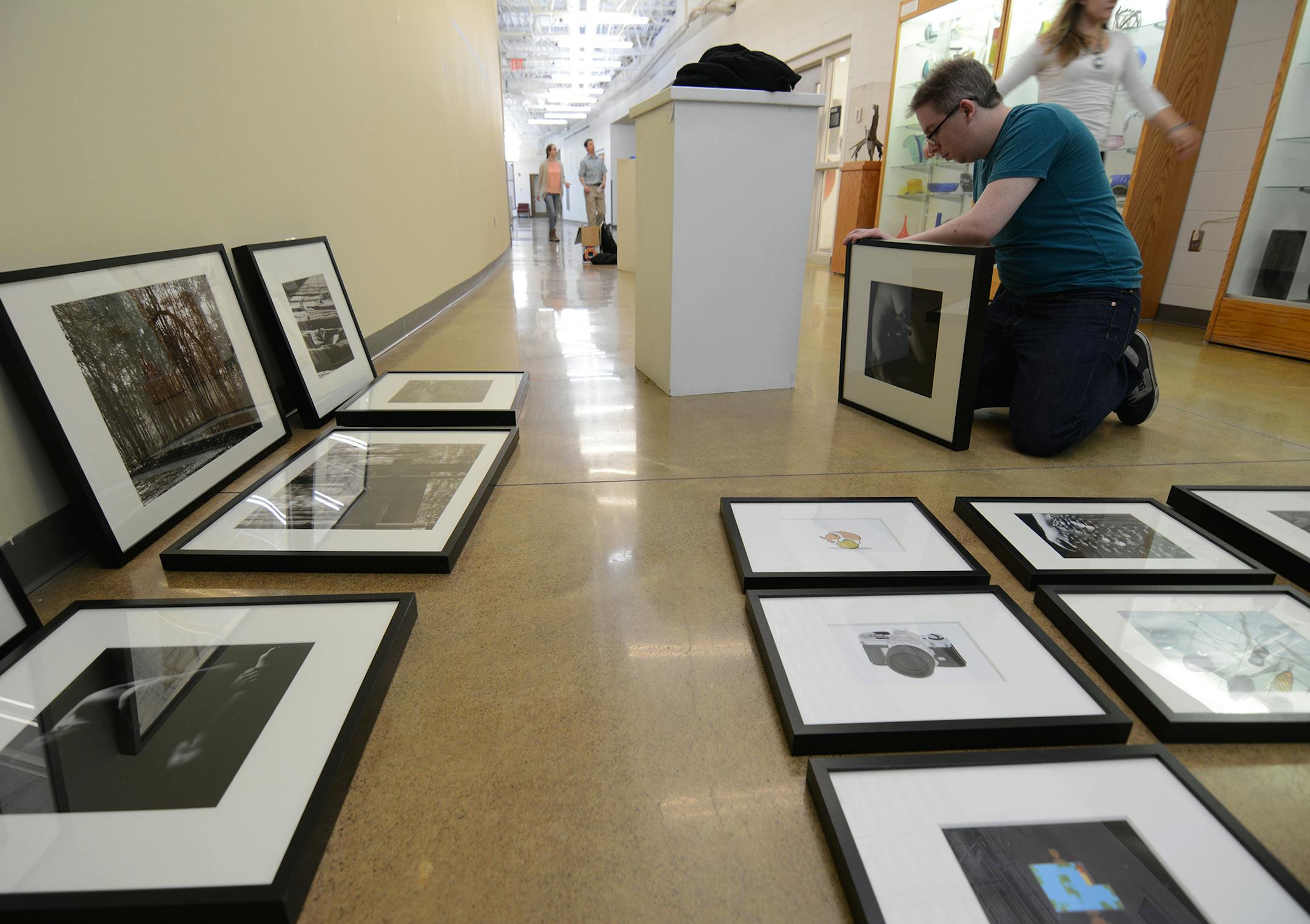 Anoka-Ramsey senior Skyler Snyder, of Minneapolis, lays out his work for the 2015 portfolio show. One of Skylerís photos won first place in a juried student art show this year, and it was purchased by the college for display. Photo by Liz Rolfsmeier, Special to the Star Tribune