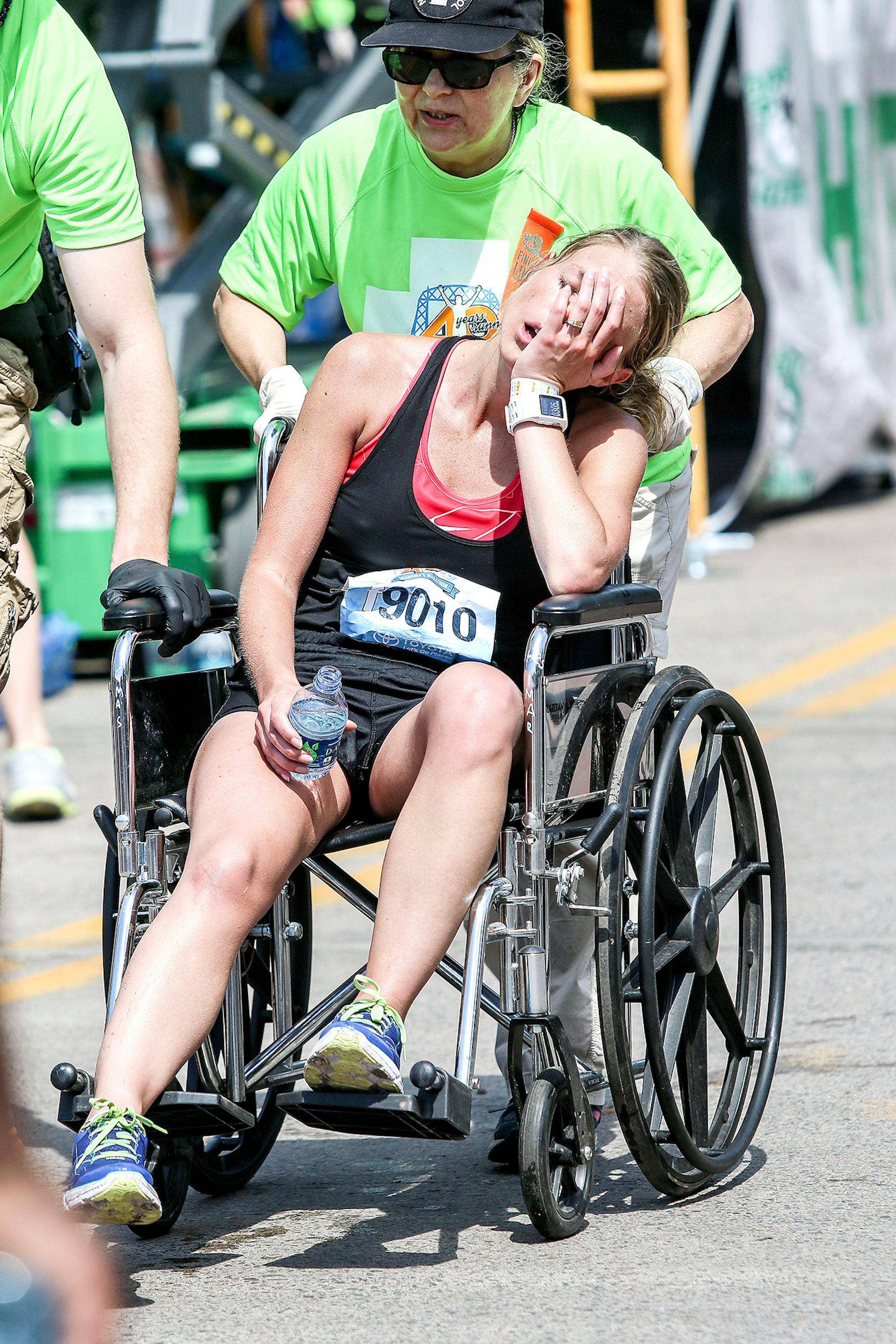 Jenna McGuire of New hope, Minn., reacts after collapsing in a wheelchair at the finish line of Grandma's Marathon in Duluth Saturday.