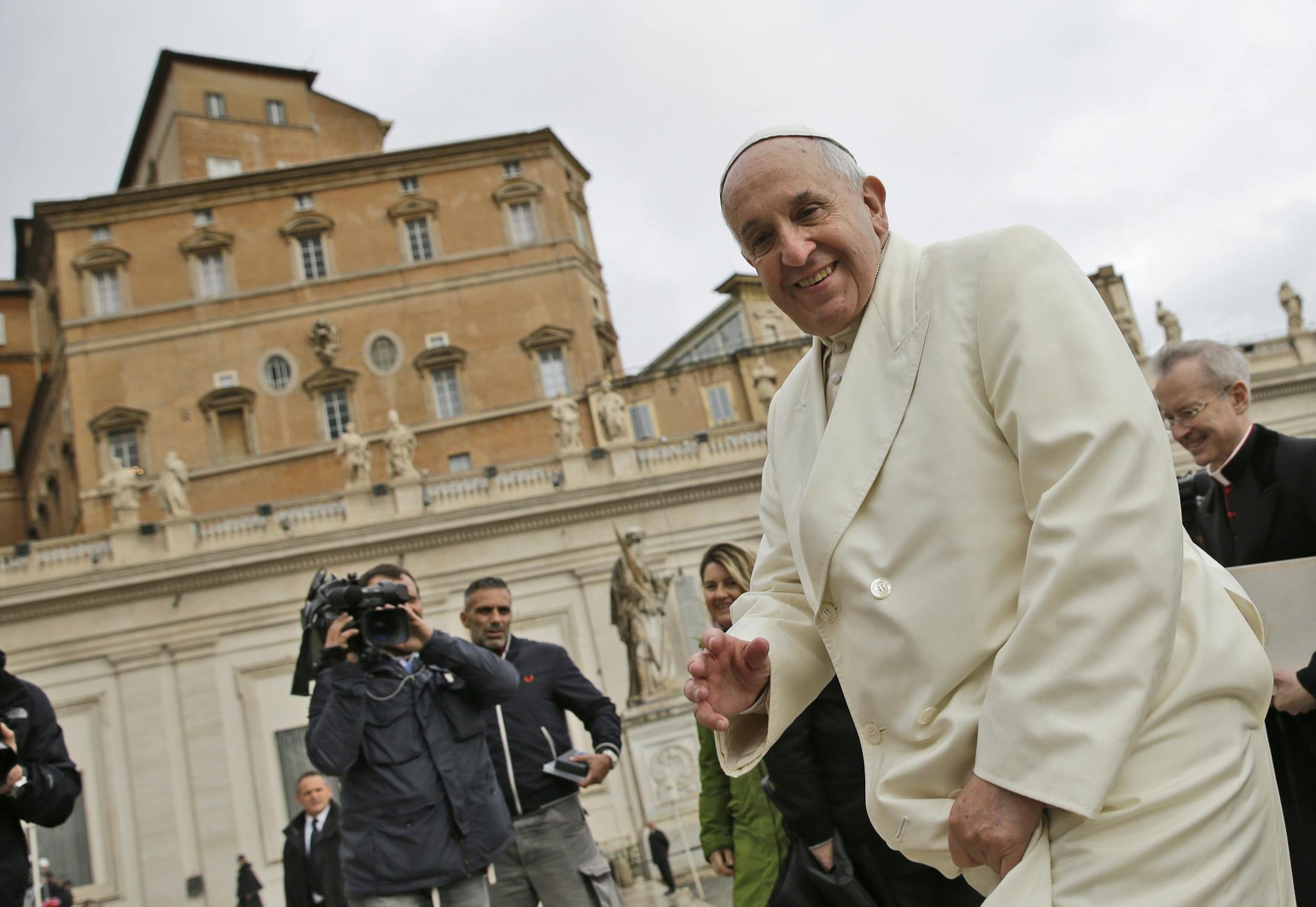 Pope Francis arrives for his weekly general audience in St. Peter's Square at the Vatican, Wednesday, Dec. 3, 2014.