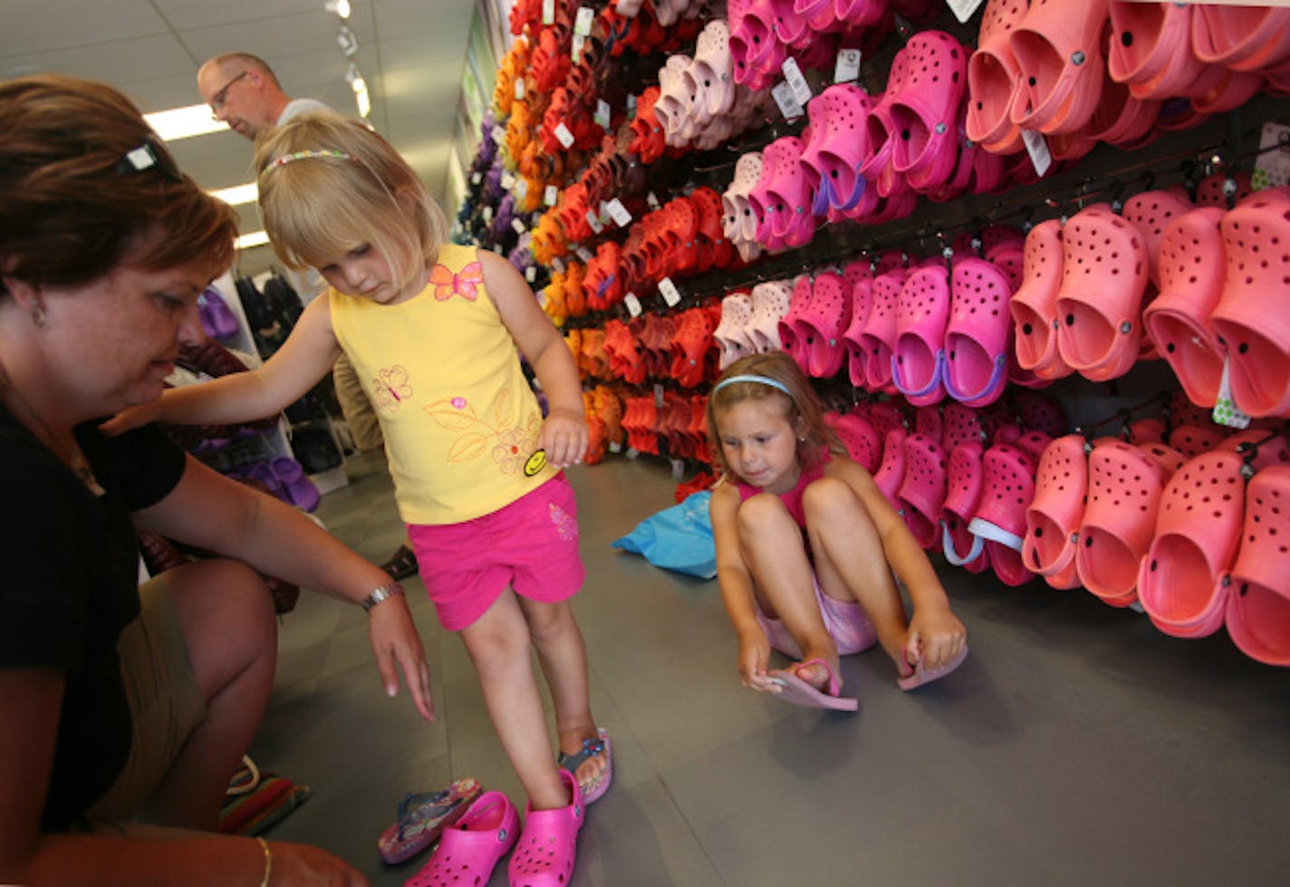 Brigitte and Brian Braun of Winnipeg took daughters Karissa, 3, and Sabrina, 5, shoe shopping at the new Crocs store last week at Albertville Premium Outlets.