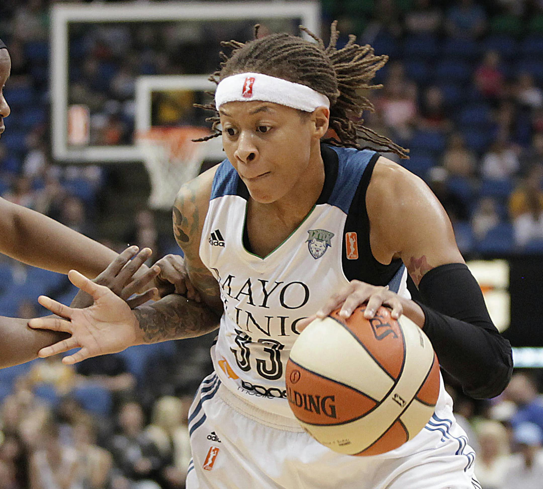 Minnesota Lynx guard Seimone Augustus (33) pushes the ball around New York Liberty guard Sugar Rogers (14) during the second half of a WNBA basketball game, Saturday, May 24, 2014, in Minneapolis. The Lynx won 87-82. (AP Photo/Stacy Bengs) ORG XMIT: MIN2014060518083718