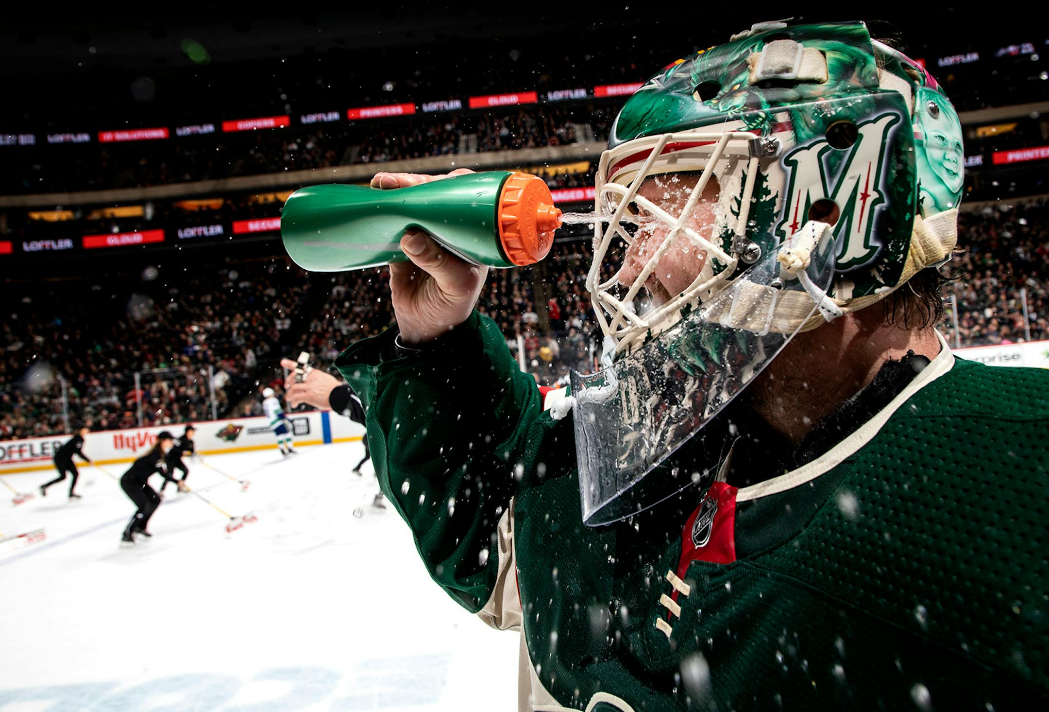 Minnesota Wild goalie Devan Dubnyk cooled himself with water in the second period.