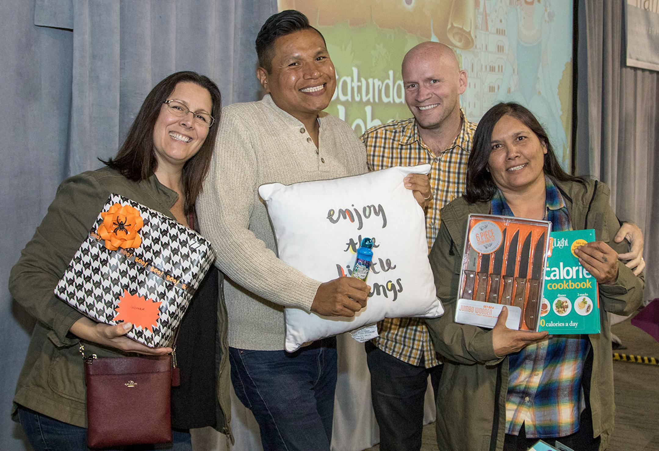 Lisa Owen, Jase Roe (showcasing pillow), Scott Gallus and Vivial Guerra show off their Mystery Prizes ($20 bought Bingo players a mystery prize package).
