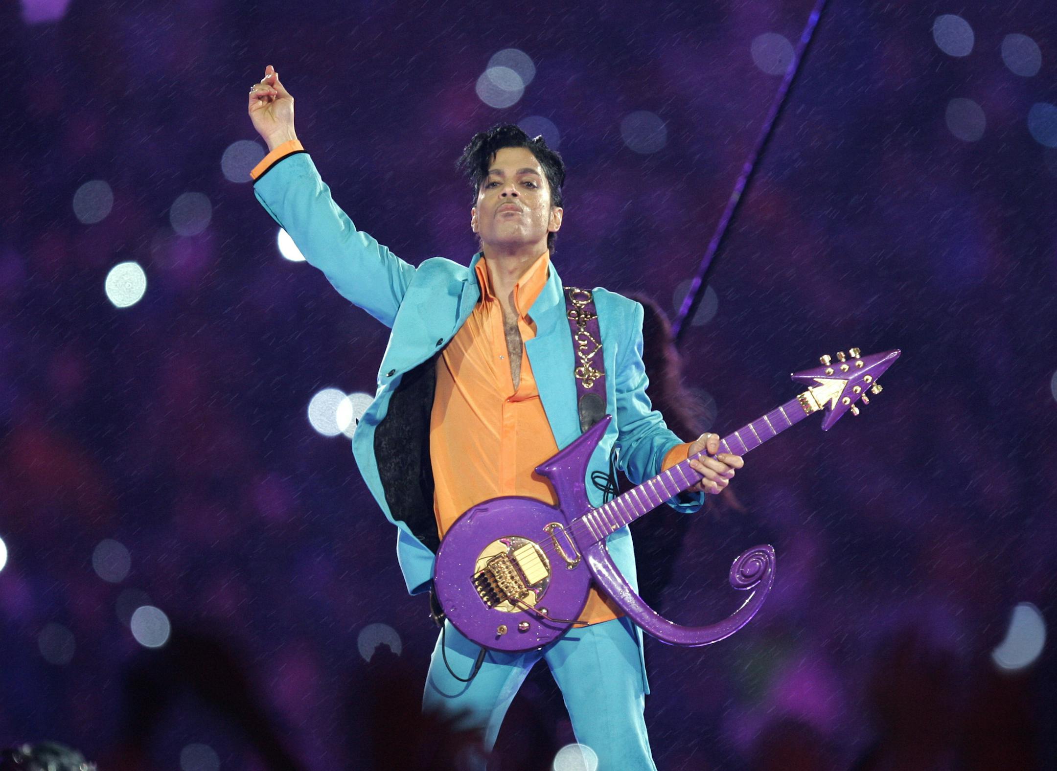 FILE - In this Feb. 4, 2007, file photo, Prince performs during the halftime show at the Super Bowl XLI football game at Dolphin Stadium in Miami. The Grammy Awards announced Wednesday Feb. 8, 2017, that Sunday's show will include tribute performances in honor of Prince and George Michael. Both stars died last year. (AP Photo/Chris O'Meara, File)