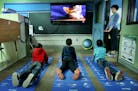 Students in the green room at Fair Oaks Elementary practiced yoga to help them focus as teacher Sarah Pinkerton guided them.