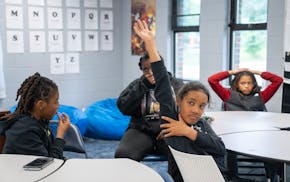 Christian, aka “Blaze”, a sixth grade student, raises his hand to answer a question during group activity time at Phelps Recreation Center in Minn